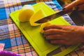 The girl cuts potatoes on a cutting board with a knife. Royalty Free Stock Photo