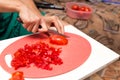 Girl cuts a tomato knife Royalty Free Stock Photo