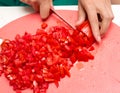 Girl cuts a tomato knife Royalty Free Stock Photo