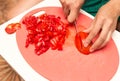 Girl cuts a tomato knife Royalty Free Stock Photo