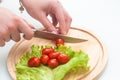 Girl is cutting cherry tomatoes Royalty Free Stock Photo