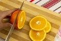 Girl Cutting Orange with Knife. Healthy Lifestyle Concept