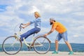 Girl cycling while man support her. Man helps keep balance ride bike. Cycling service. Service and assistance. Mechanic Royalty Free Stock Photo