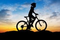 Girl cycling at mountain twilight time