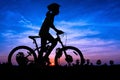 Girl cycling at mountain twilight time