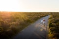 Beautiful blonde surfer girl on her way to the beach on her bicycle with her surfboard. Royalty Free Stock Photo