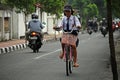 Girl cycling in Yogyakarta