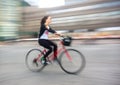 Girl cyclist in traffic on the city roadway