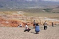 A girl with a dachshund takes pictures of another girl