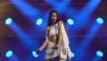 Girl dance in greek greece goddes dress and wreath high fashion. Young hot brunette with long hair and red lips. Neon