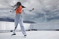 Girl, dance and hip hop outdoor on city rooftop with lightning storm and cool gen z streetwear fashion. Woman, moving