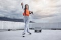 Girl, dance and hip hop outdoor on city rooftop with music, speaker and cool gen z streetwear fashion. Woman, moving and