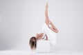 Girl in a dance pose on a white background. Flexibility, strength Royalty Free Stock Photo