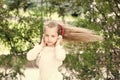 Girl dance to music in summer park. Small child enjoy music in headphones outdoor. Kid dancer with long flying hair Royalty Free Stock Photo