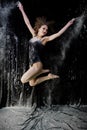 Girl dancer jumping and dancing on a black background. Royalty Free Stock Photo