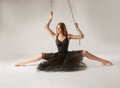 Slender girl dancing with a large chain in an incredible ballerina pose