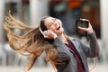 Girl dancing and listening music in the street Royalty Free Stock Photo