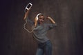 Girl dancing and listening to music in a mobile application.