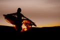 Girl dancing at sunset in a transparent dress. The sun shines beautifully through the fabric.