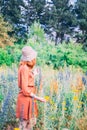 Girl on dandelion on green field. Royalty Free Stock Photo