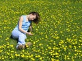 Girl on dandelion lawn Royalty Free Stock Photo