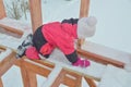 a girl is dangerous to climb on the construction of a frame house in the winter, a brave child