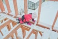 a girl is dangerous to climb on the construction of a frame house in the winter, a brave child