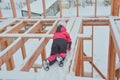 a girl is dangerous to climb on the construction of a frame house in the winter, a brave child