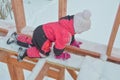 a girl is dangerous to climb on the construction of a frame house in the winter, a brave child