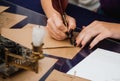 girl with a dark manicure writes a letter in red on an old brown goose quill with ink on old brown parchment Royalty Free Stock Photo