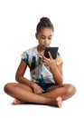 Girl, dark-skinned teenager looks at the screen of the tablet