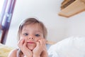 Girl daughter looking at camera as she is waiting her parents to wake up from bed at morning. Happy relaxed family life Royalty Free Stock Photo