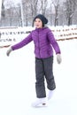 Girl in dawn jacket skating on the ice rink Royalty Free Stock Photo