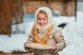 Girl on the day of the carnival treats pancakes Royalty Free Stock Photo