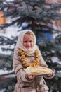 Girl on the day of the carnival treats pancakes Royalty Free Stock Photo