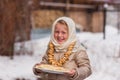 Girl on the day of the carnival treats pancakes Royalty Free Stock Photo