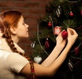 Girl decorate the Christmas tree