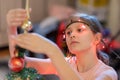 The girl decorates the Christmas tree. Children in Xmas Royalty Free Stock Photo