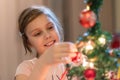 The girl decorates the Christmas tree. Children in Xmas. Royalty Free Stock Photo