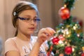 The girl decorates the Christmas tree. Children in Xmas Royalty Free Stock Photo