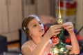 The girl decorates the Christmas tree. Children in Xmas Royalty Free Stock Photo