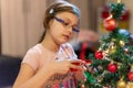 The girl decorates the Christmas tree. Children in Xmas Royalty Free Stock Photo