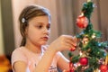 The girl decorates the Christmas tree. Children in Xmas Royalty Free Stock Photo