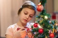 The girl decorates the Christmas tree. Children in Xmas Royalty Free Stock Photo