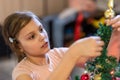 The girl decorates the Christmas tree. Children in Xmas Royalty Free Stock Photo