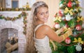 Girl decorates Christmas tree