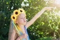 Girl with decoration of flowers on her head makes a funny face. Royalty Free Stock Photo