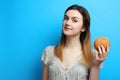 Girl with a delicious sweet bun Royalty Free Stock Photo