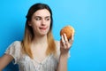 Girl with a delicious sweet bun Royalty Free Stock Photo