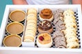 Girl Delivering The Diverse Sweets In A Box To The Table. Royalty Free Stock Photo